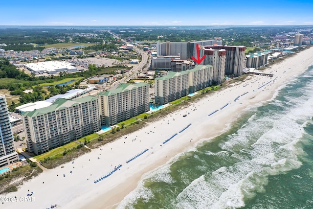 bird's eye view featuring a water view and a beach view