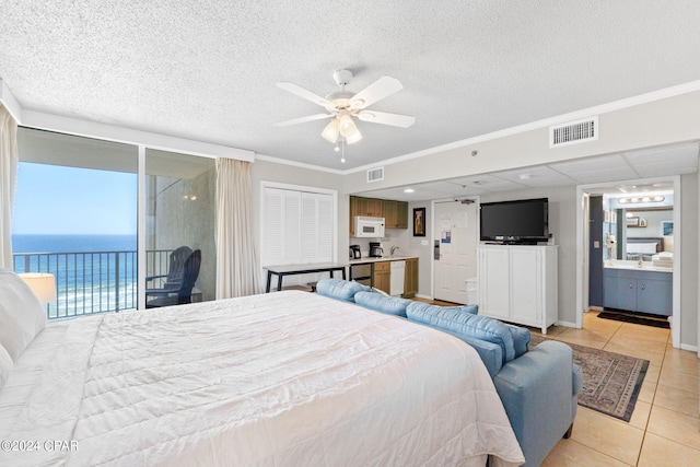 bedroom with ceiling fan, light tile patterned floors, crown molding, access to outside, and a water view