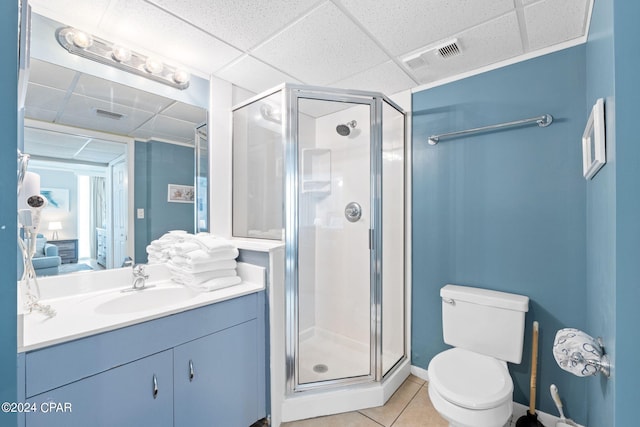 bathroom with tile patterned flooring, an enclosed shower, toilet, a paneled ceiling, and vanity