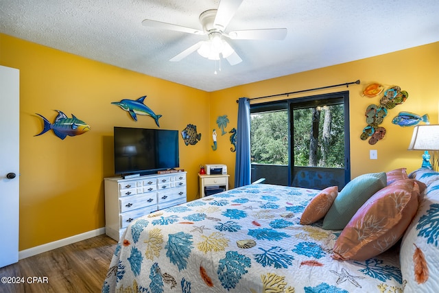 bedroom featuring a textured ceiling, ceiling fan, hardwood / wood-style floors, and access to outside