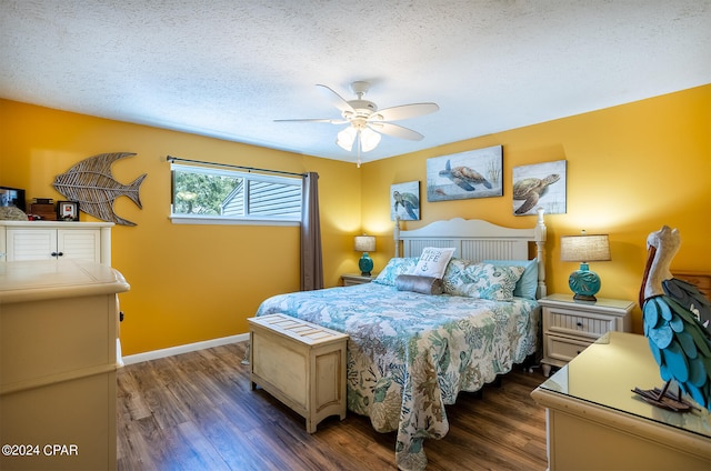 bedroom with ceiling fan, dark hardwood / wood-style flooring, and a textured ceiling