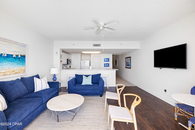 living room with wood-type flooring and ceiling fan