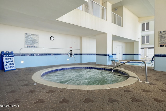 view of pool with an indoor hot tub