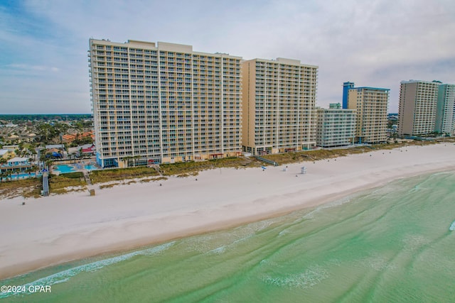 drone / aerial view with a beach view and a water view