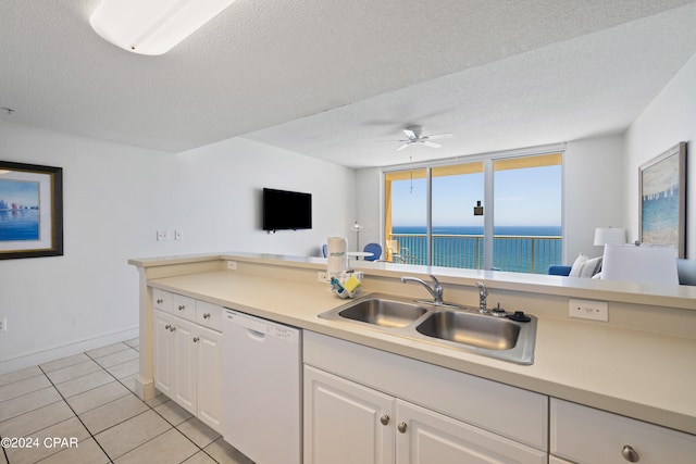 kitchen featuring dishwasher, ceiling fan, white cabinets, sink, and light tile floors