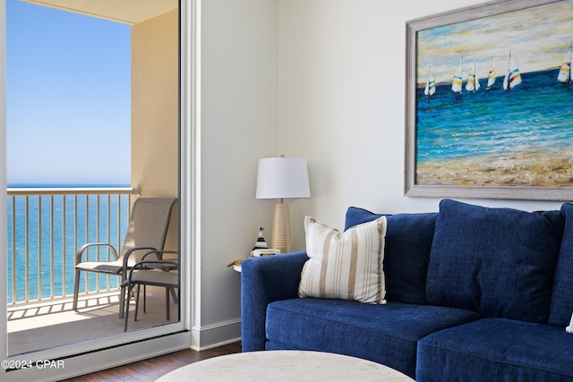 living room featuring a water view and hardwood / wood-style floors