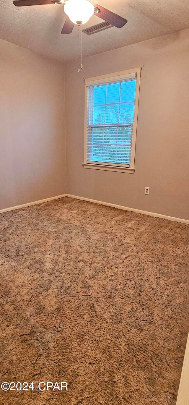 unfurnished room with ceiling fan and carpet floors