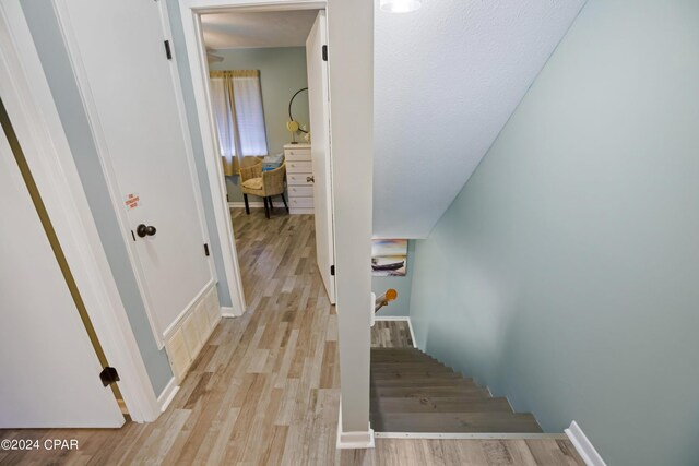 stairs featuring light wood-type flooring