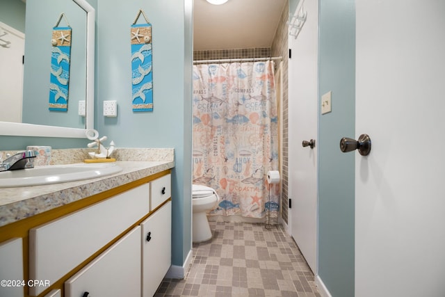 bathroom with tile flooring, vanity, and toilet