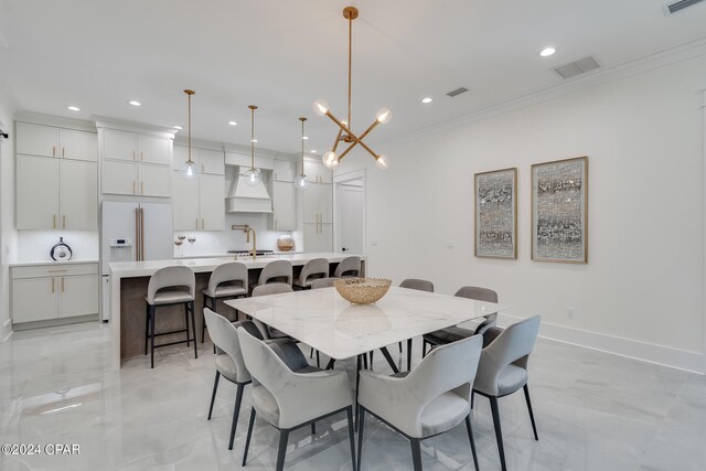 dining room with crown molding and a notable chandelier