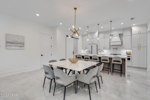 dining space with a barn door, crown molding, and a notable chandelier