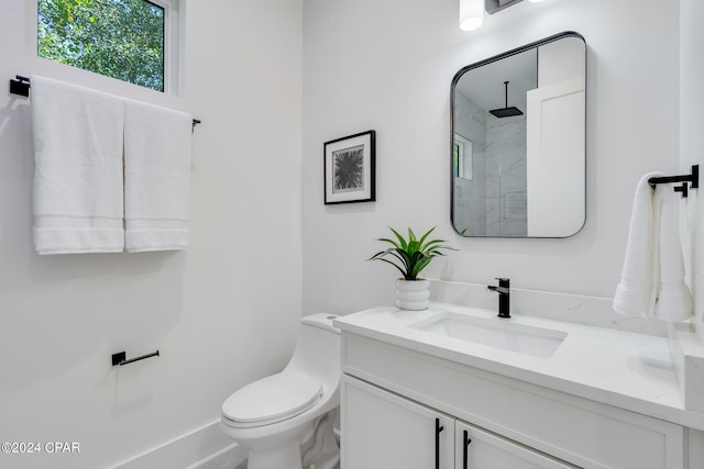 bathroom with vanity, toilet, and walk in shower