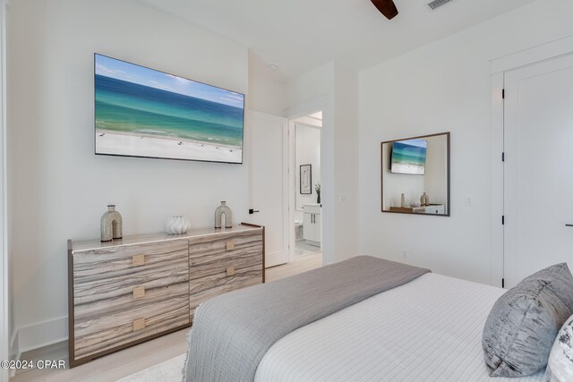 bedroom featuring ensuite bath and ceiling fan