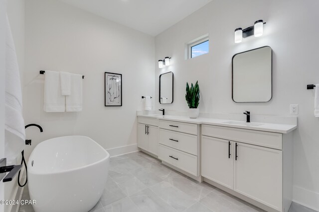 bathroom featuring vanity, a bathing tub, and tile patterned floors