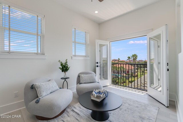 living area featuring a wealth of natural light and light hardwood / wood-style floors