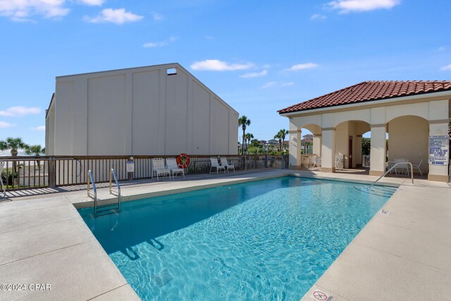 view of swimming pool with a patio area