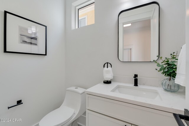 bathroom with toilet and vanity