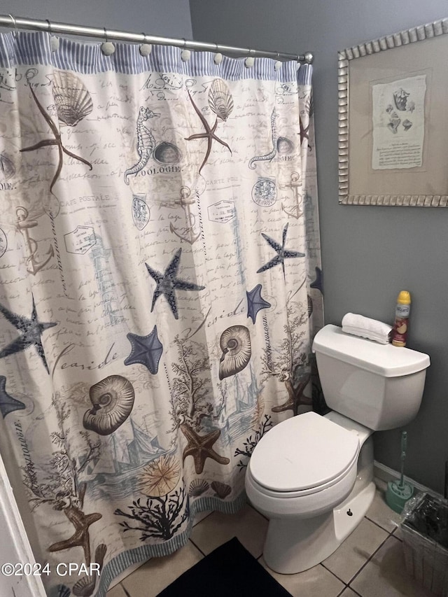 bathroom with tile patterned floors, a shower with shower curtain, and toilet