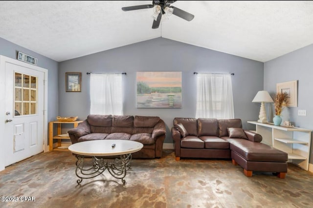 carpeted living room with a textured ceiling, plenty of natural light, lofted ceiling, and ceiling fan