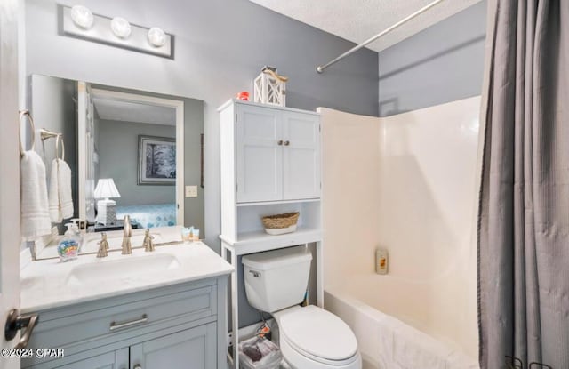 full bathroom featuring vanity, shower / bath combination with curtain, a textured ceiling, and toilet