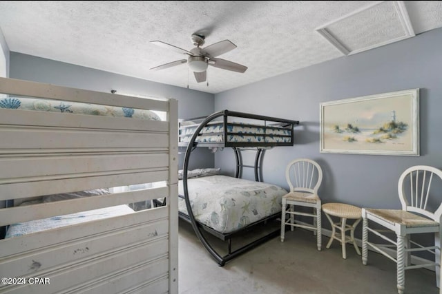 bedroom with a textured ceiling and ceiling fan