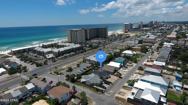 birds eye view of property with a water view and a view of the beach