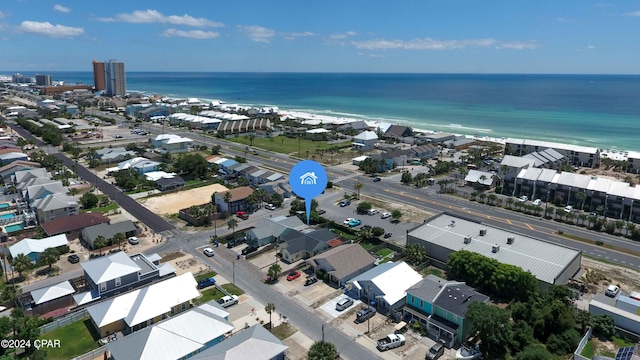 birds eye view of property featuring a beach view and a water view