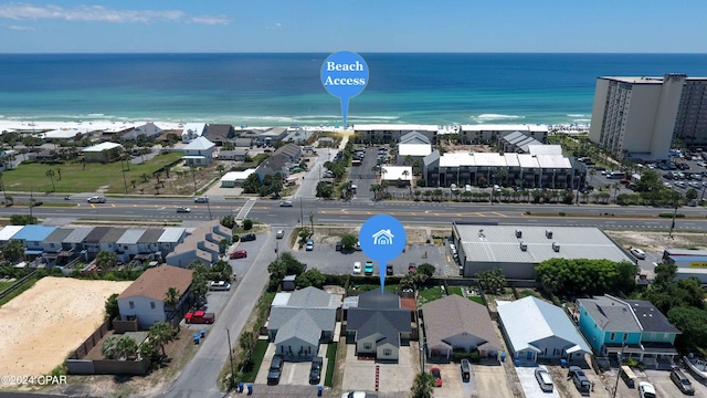 bird's eye view with a water view and a beach view