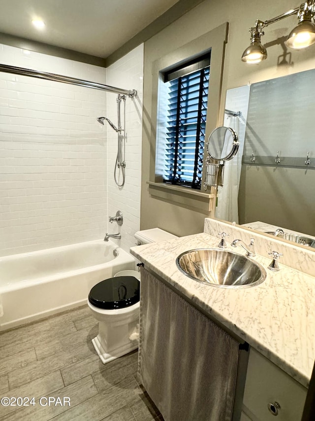 full bathroom featuring vanity, toilet, and tiled shower / bath