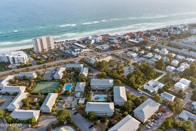 bird's eye view with a water view and a beach view