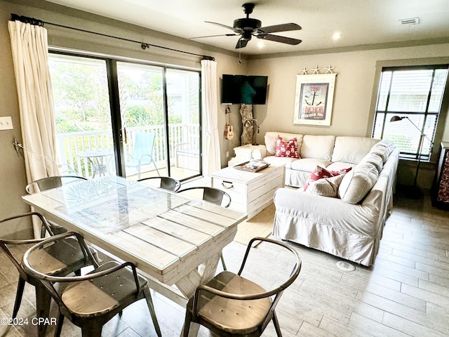 living room with ceiling fan and a healthy amount of sunlight