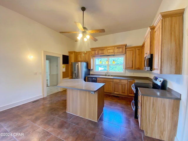 kitchen featuring sink, a kitchen island, stainless steel appliances, and ceiling fan