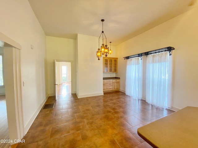 unfurnished dining area with a notable chandelier