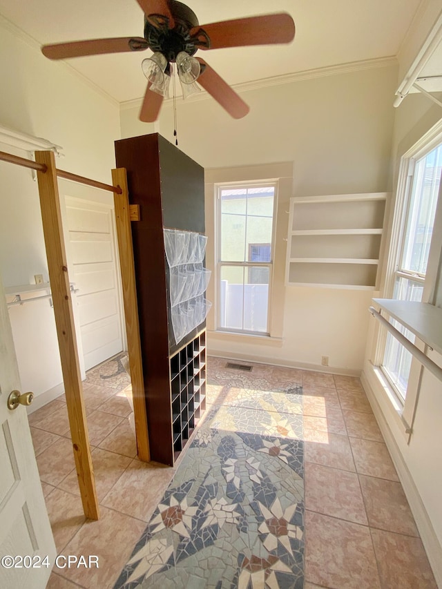 tiled bedroom featuring ornamental molding and ceiling fan