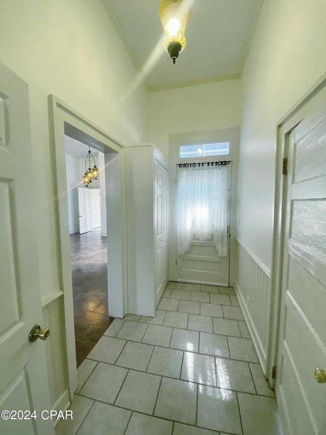 doorway to outside featuring a chandelier