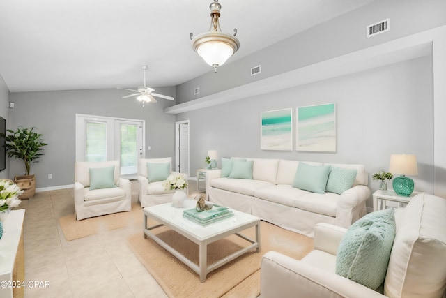 tiled living room with ceiling fan and vaulted ceiling