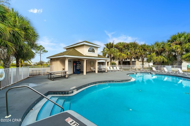 pool featuring a patio and fence