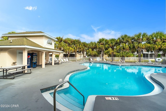 pool featuring a patio and fence