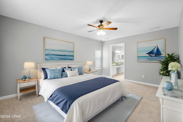 bedroom with connected bathroom, ceiling fan, and light colored carpet