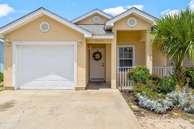 ranch-style home featuring stucco siding, driveway, a porch, roof with shingles, and a garage