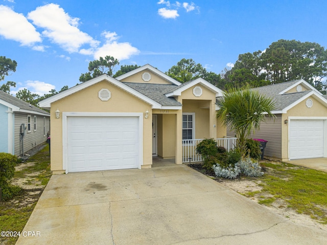 single story home with stucco siding, concrete driveway, a garage, and a shingled roof