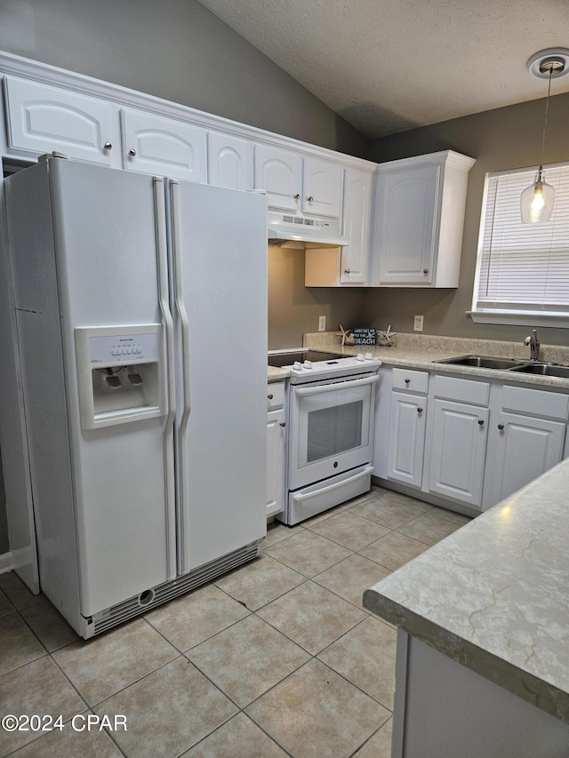 kitchen with under cabinet range hood, white appliances, white cabinetry, and a sink