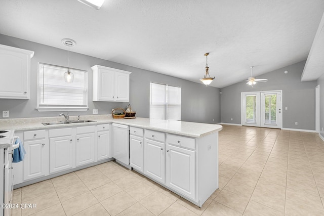 kitchen featuring a peninsula, white dishwasher, a sink, light countertops, and white cabinets