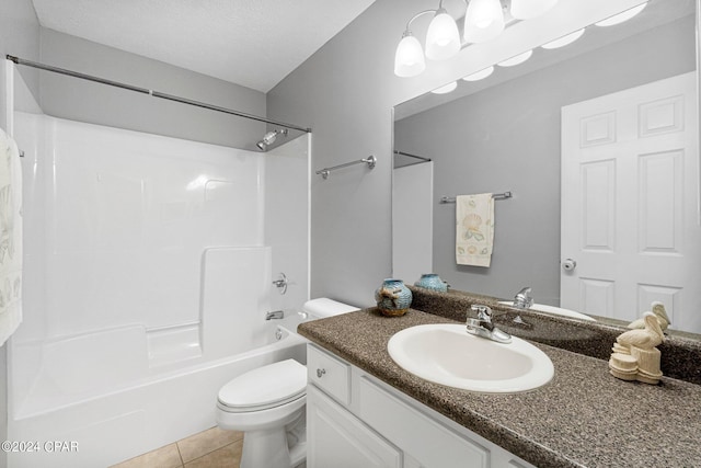 bathroom featuring tile patterned floors, toilet, a textured ceiling, tub / shower combination, and vanity