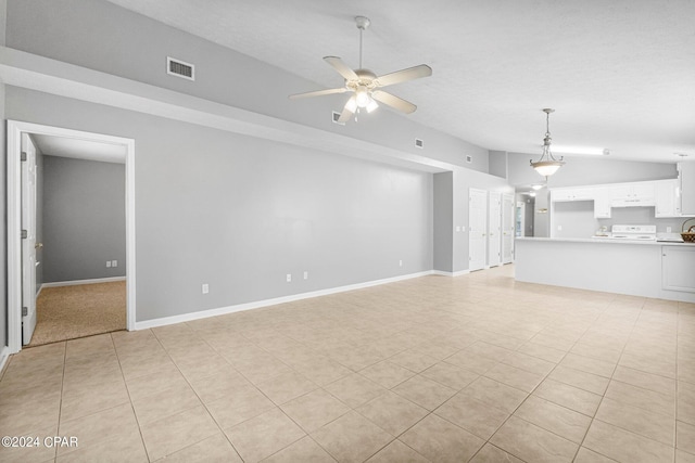 unfurnished living room featuring visible vents, lofted ceiling, baseboards, and ceiling fan