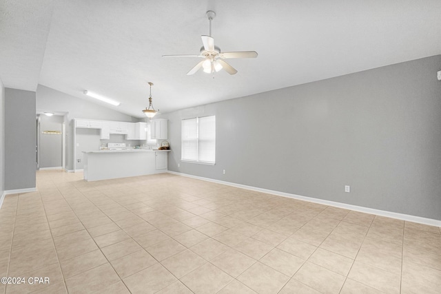 unfurnished living room featuring lofted ceiling, baseboards, and ceiling fan