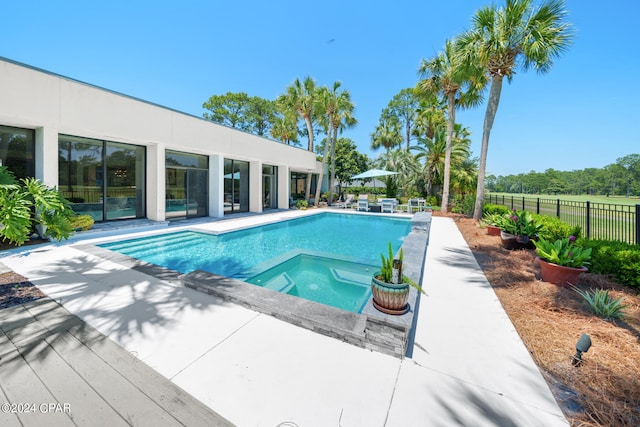 view of pool featuring a patio and an in ground hot tub