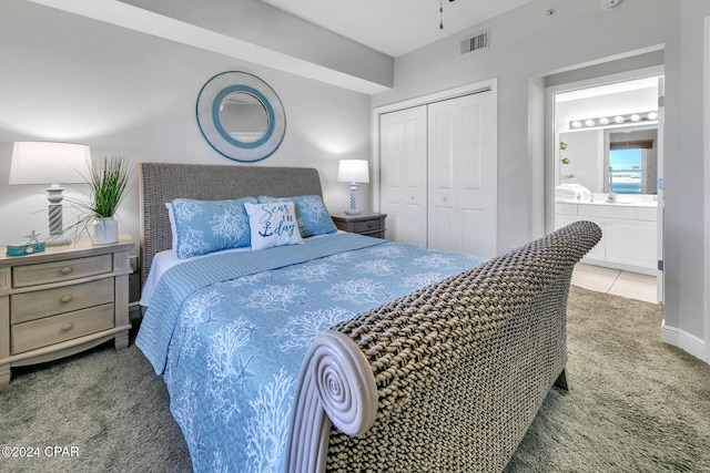 carpeted bedroom featuring connected bathroom and a closet