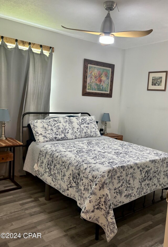 bedroom with wood-type flooring and ceiling fan