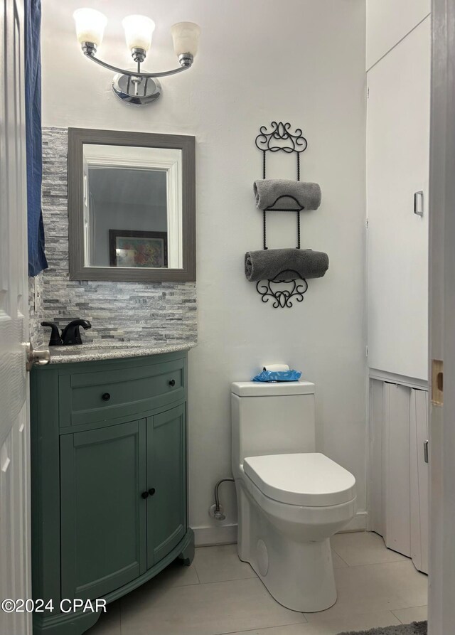 bathroom featuring toilet, tasteful backsplash, vanity, and tile patterned floors